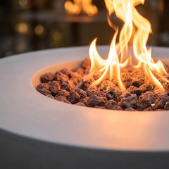 Close-up of flames over lava rock in the Modeno Roca's recessed concrete bowl