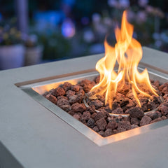 Close-up of flames over lava rock in the stainless tray of the Modeno Westport