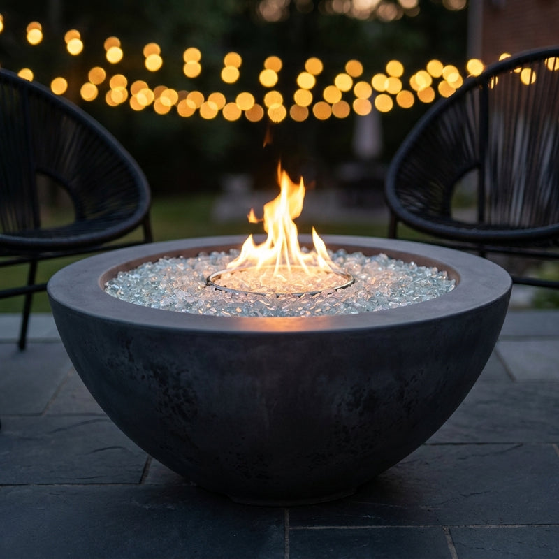 Outdoor Greatroom Cove 42 Midnight Mist round gas fire bowl burning at dusk
