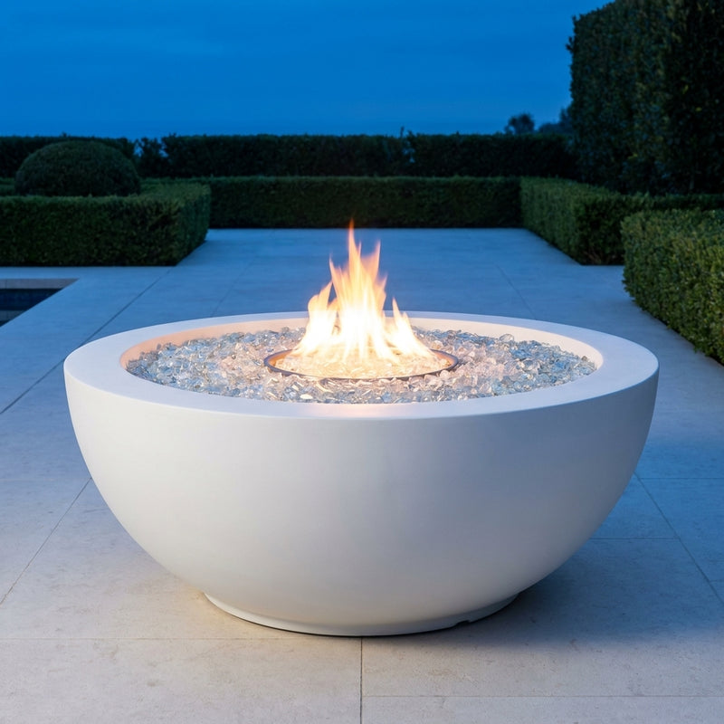 Outdoor Greatroom Cove 42 White round gas fire bowl burning at dusk
