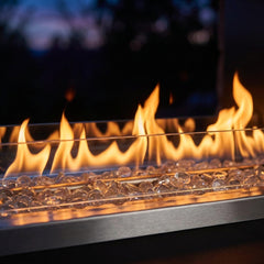 Close-up of the linear flame over clear fire glass in the Outdoor Greatroom RLFP60 outdoor fireplace