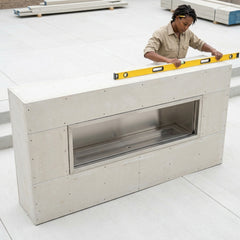 Installer leveling the 9-foot Outdoor Greatroom RLFP-72 ready-to-finish single-sided fireplace enclosure before cladding