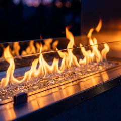 Close-up of the linear flame over clear fire glass in the Outdoor Greatroom RSTL40 outdoor fireplace