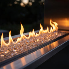 Close-up of the linear flame over clear fire glass in the Outdoor Greatroom RSTL60 outdoor fireplace